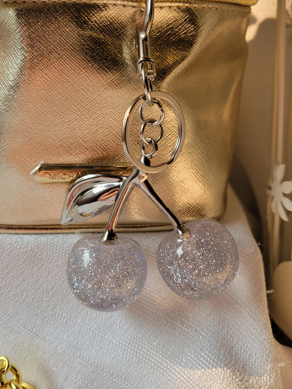 Michael Kors Metallic Cosmetic Case & 5 Piece Cherry Bag Charm Bundle